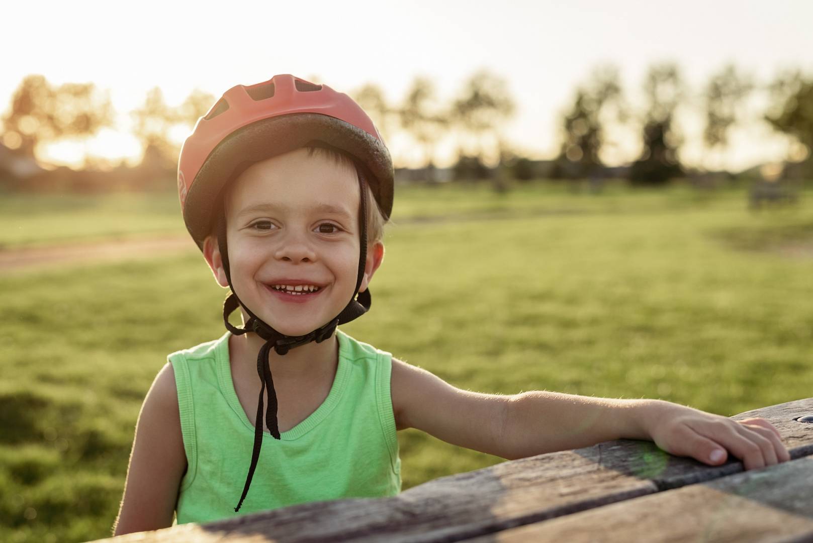 little-boy-in-a-bicycle-helmet-sitting-at-a-picnic-2022-11-16-16-03-52-utc.jpg